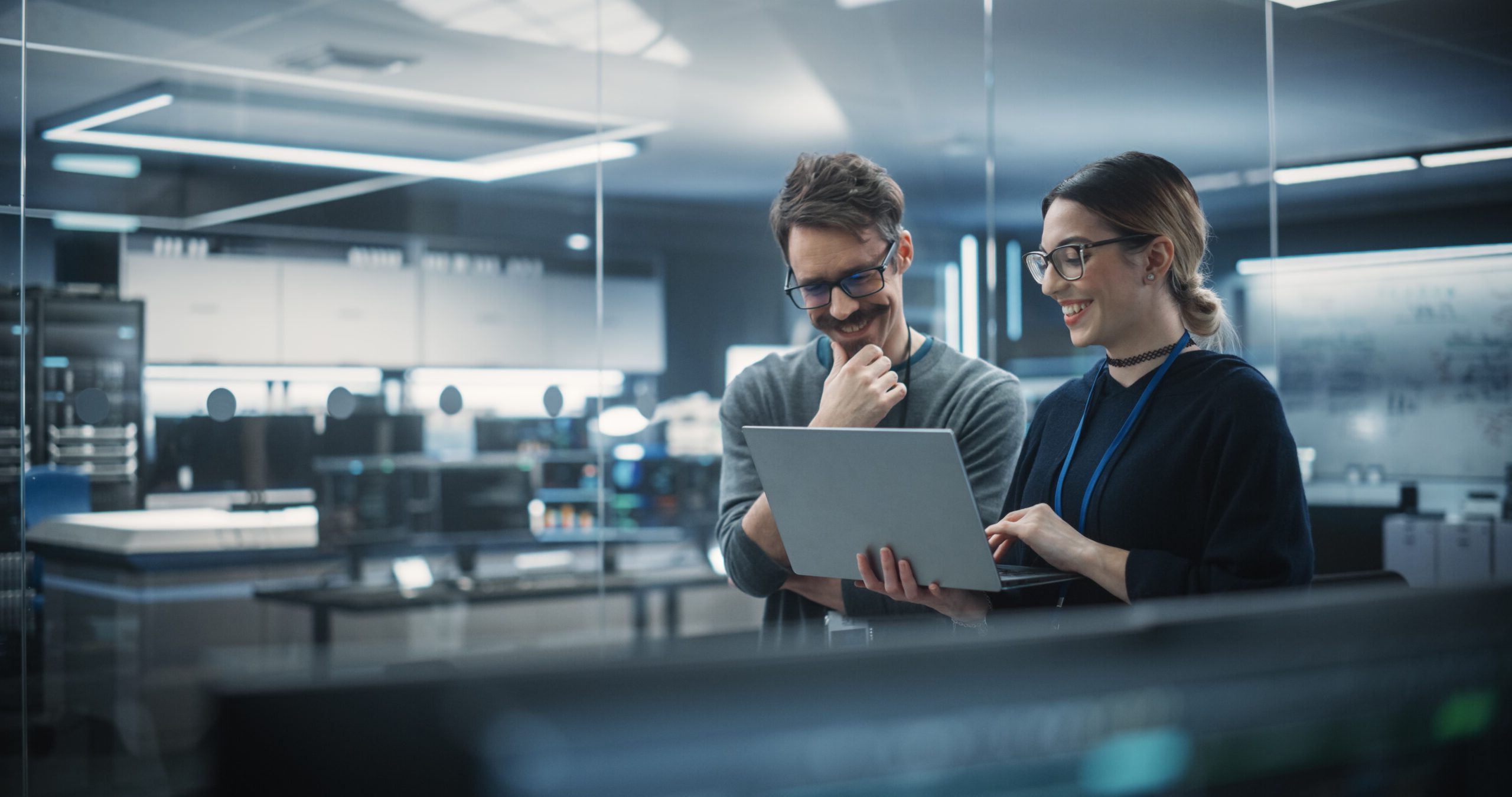 Portrait of Two Creative Young Female and Male Engineers Using