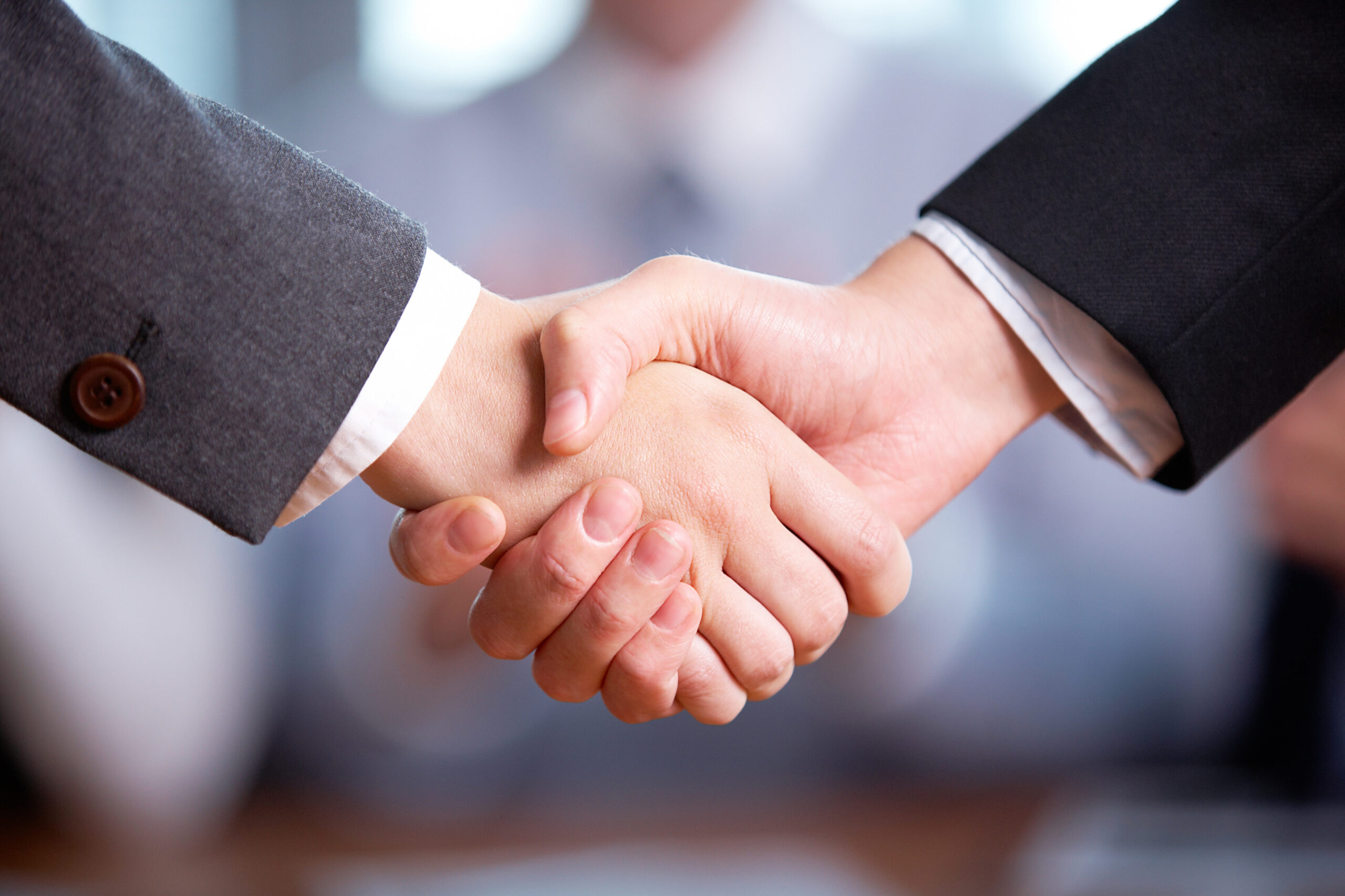 close-up photo of handshake of business partners after striking deal